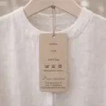 Printed custom hang tag on a white linen shirt