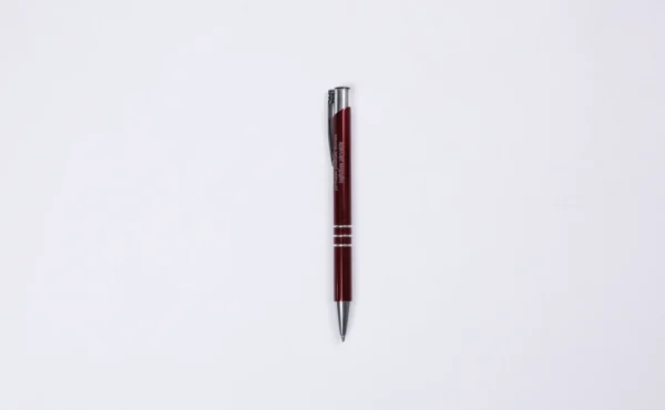 Red engraved metal pen BASIC on a white background