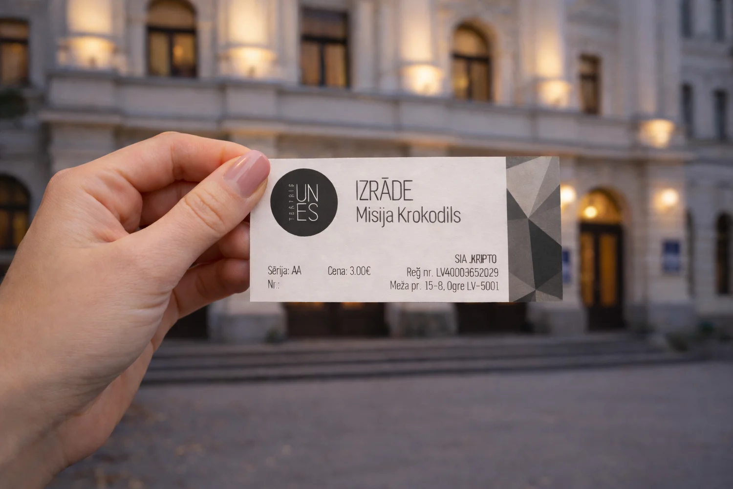 Hand holding a custom printed theater ticket with perforation and numbering in front of a building