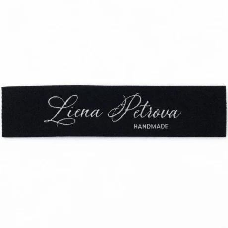 Black custom woven jacquard label with Liena Petrova HANDMADE text